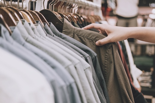 flipping through clothes on hangers 